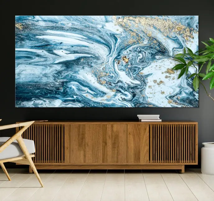 An eye-catching abstract wall art piece titled "Ice Blue Marble Fluid Effect" comes in a three-panel canvas. It is crafted on museum-quality polycotton canvas and features a UV-protective coating, making it an elegant addition to any living space.