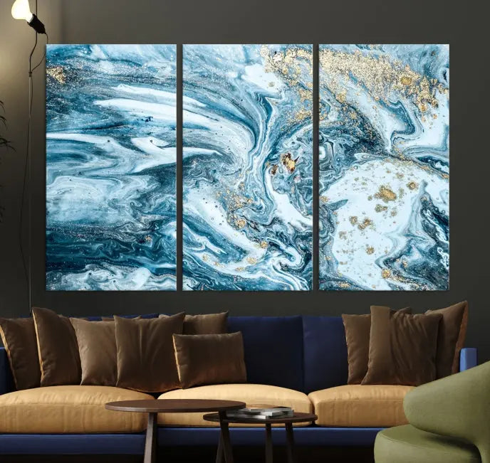 An eye-catching abstract wall art piece titled "Ice Blue Marble Fluid Effect" comes in a three-panel canvas. It is crafted on museum-quality polycotton canvas and features a UV-protective coating, making it an elegant addition to any living space.