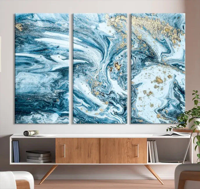 An eye-catching abstract wall art piece titled "Ice Blue Marble Fluid Effect" comes in a three-panel canvas. It is crafted on museum-quality polycotton canvas and features a UV-protective coating, making it an elegant addition to any living space.