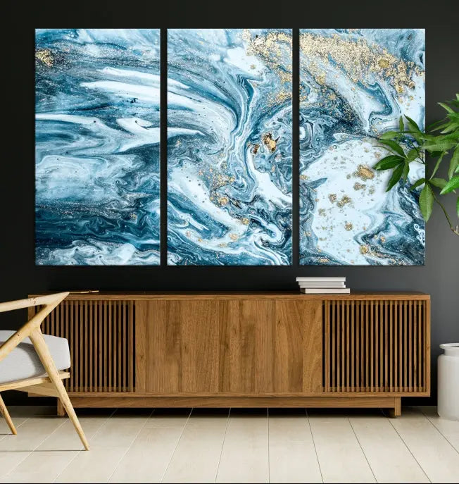 An eye-catching abstract wall art piece titled "Ice Blue Marble Fluid Effect" comes in a three-panel canvas. It is crafted on museum-quality polycotton canvas and features a UV-protective coating, making it an elegant addition to any living space.