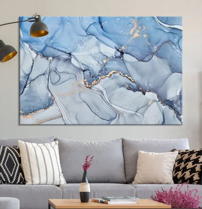 The "Ice Blue Marble Fluid Effect" abstract canvas wall art print, featuring a three-panel design, adorns the wall.