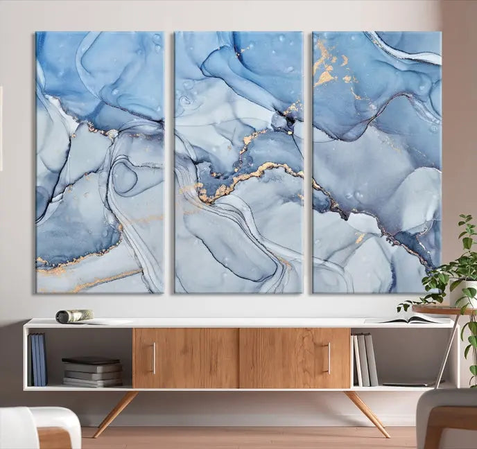 The "Ice Blue Marble Fluid Effect" abstract canvas wall art print, featuring a three-panel design, adorns the wall.