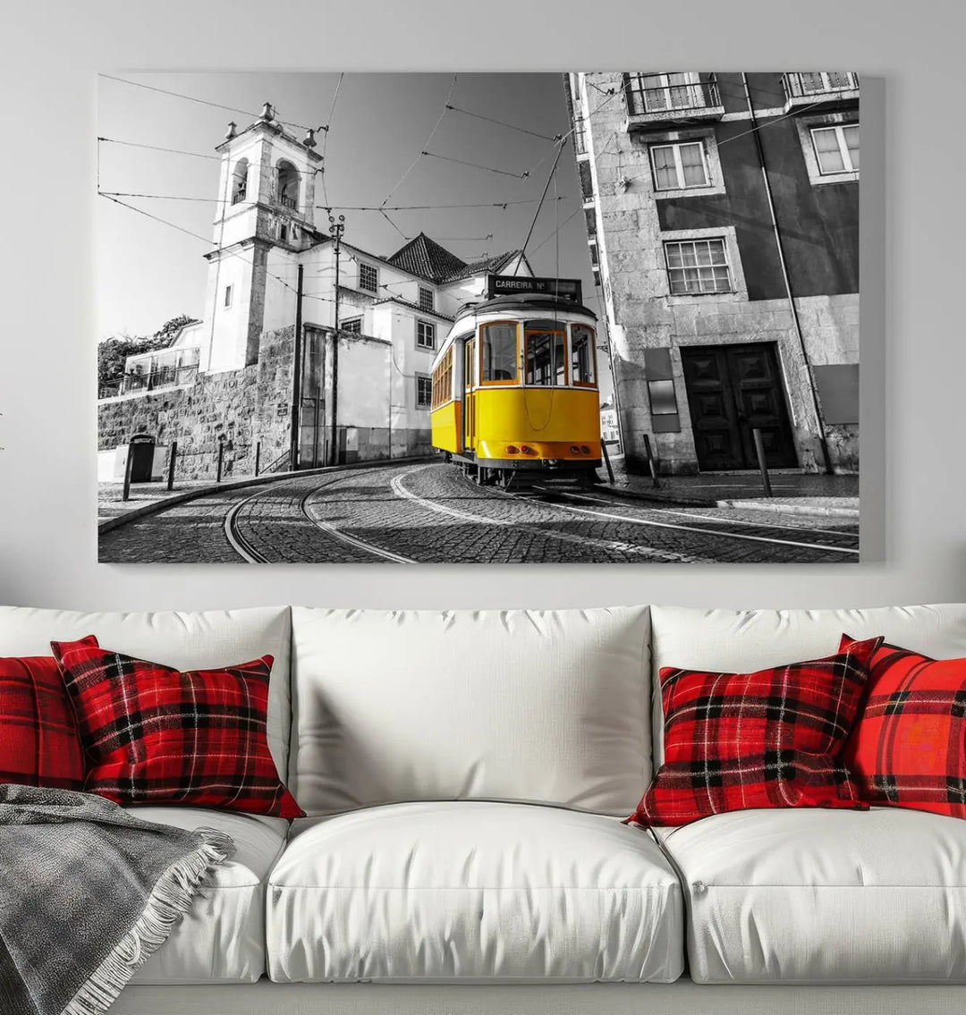 The Iconic Yellow Lisbon Tram Canvas Wall Art Print showcases a yellow tram navigating through a monochrome street scene, with a historic building in the background, exquisitely captured on museum-quality canvas.