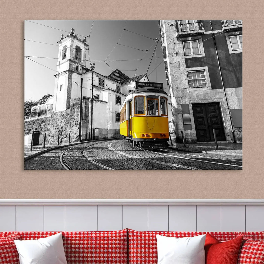 The Iconic Yellow Lisbon Tram Canvas Wall Art Print showcases a yellow tram navigating through a monochrome street scene, with a historic building in the background, exquisitely captured on museum-quality canvas.