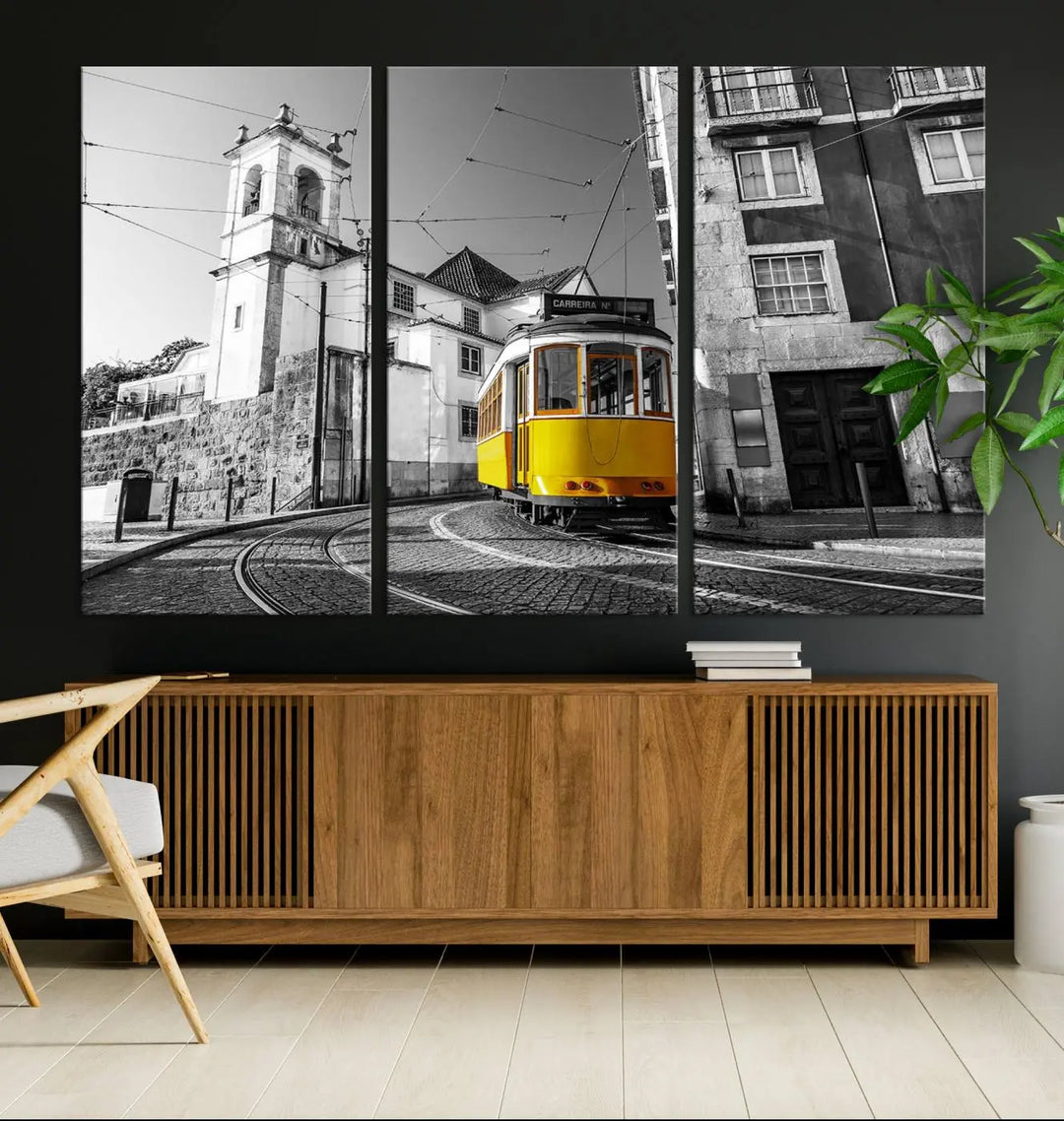 The Iconic Yellow Lisbon Tram Canvas Wall Art Print showcases a yellow tram navigating through a monochrome street scene, with a historic building in the background, exquisitely captured on museum-quality canvas.