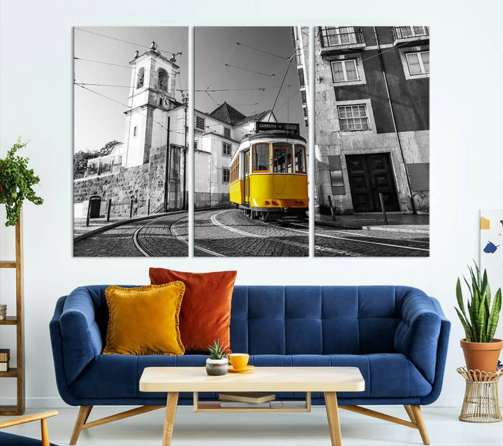 The Iconic Yellow Lisbon Tram Canvas Wall Art Print showcases a yellow tram navigating through a monochrome street scene, with a historic building in the background, exquisitely captured on museum-quality canvas.