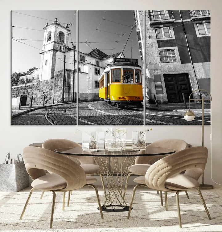 The Iconic Yellow Lisbon Tram Canvas Wall Art Print showcases a yellow tram navigating through a monochrome street scene, with a historic building in the background, exquisitely captured on museum-quality canvas.