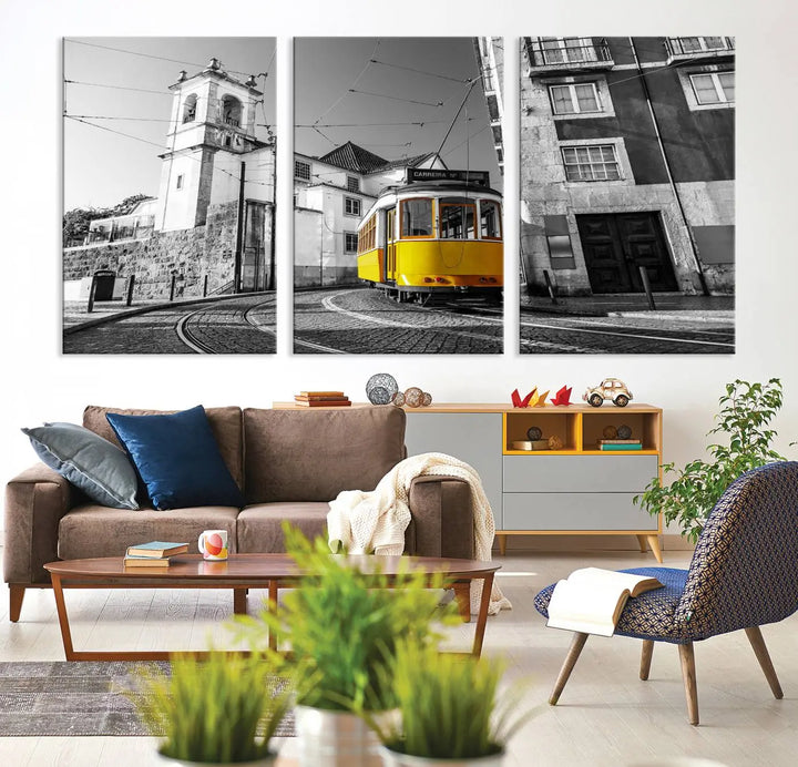 The Iconic Yellow Lisbon Tram Canvas Wall Art Print showcases a yellow tram navigating through a monochrome street scene, with a historic building in the background, exquisitely captured on museum-quality canvas.