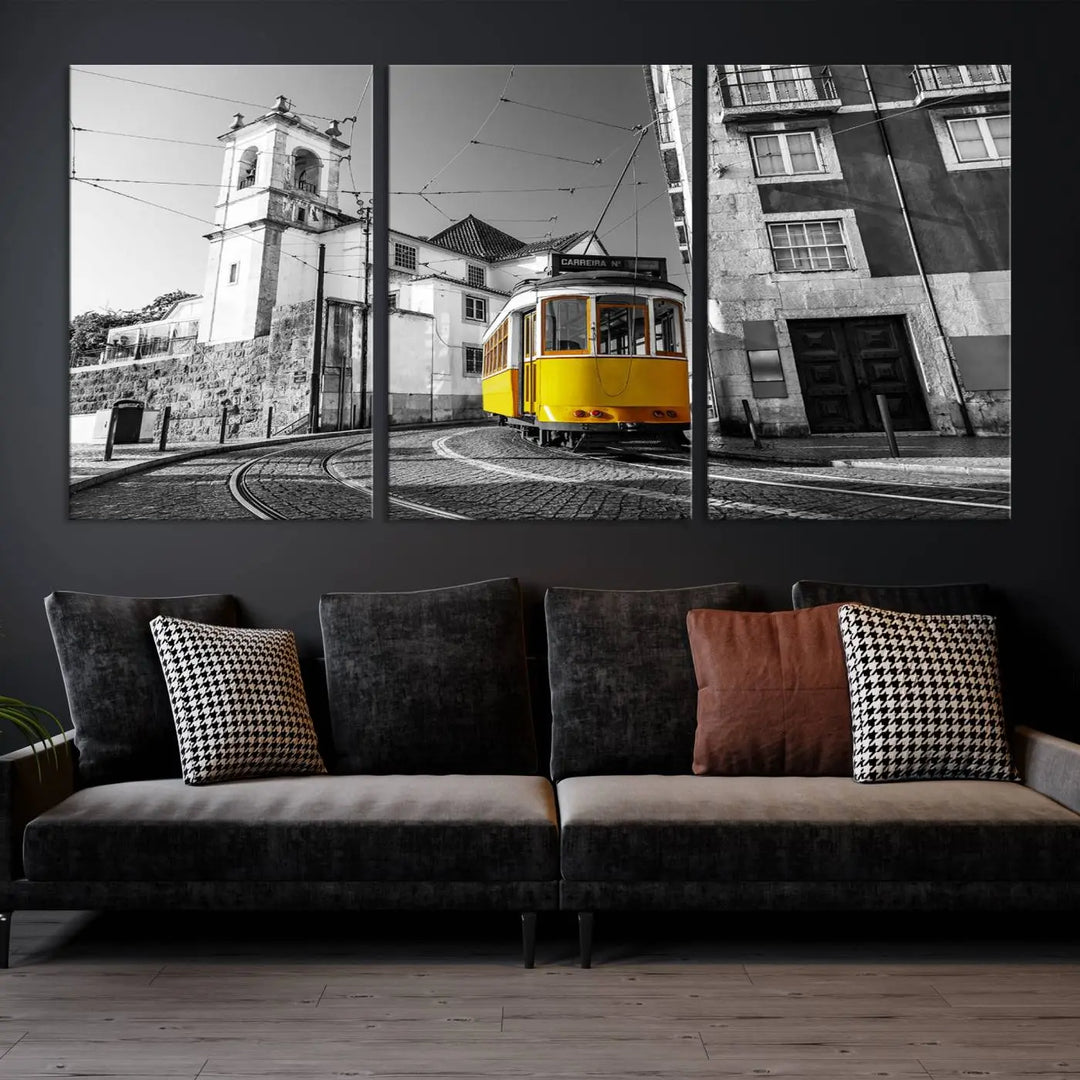 The Iconic Yellow Lisbon Tram Canvas Wall Art Print showcases a yellow tram navigating through a monochrome street scene, with a historic building in the background, exquisitely captured on museum-quality canvas.