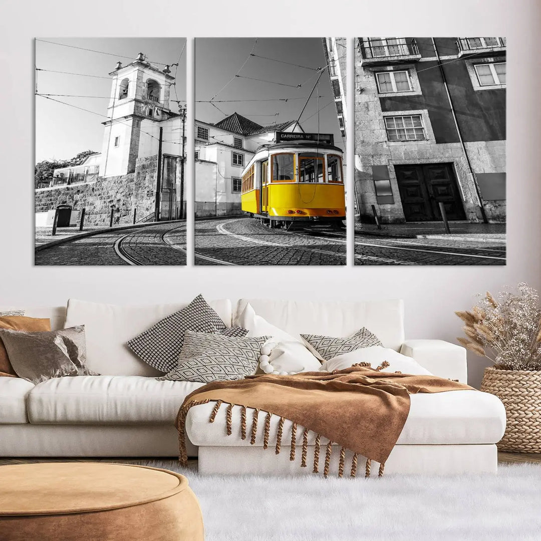 The Iconic Yellow Lisbon Tram Canvas Wall Art Print showcases a yellow tram navigating through a monochrome street scene, with a historic building in the background, exquisitely captured on museum-quality canvas.