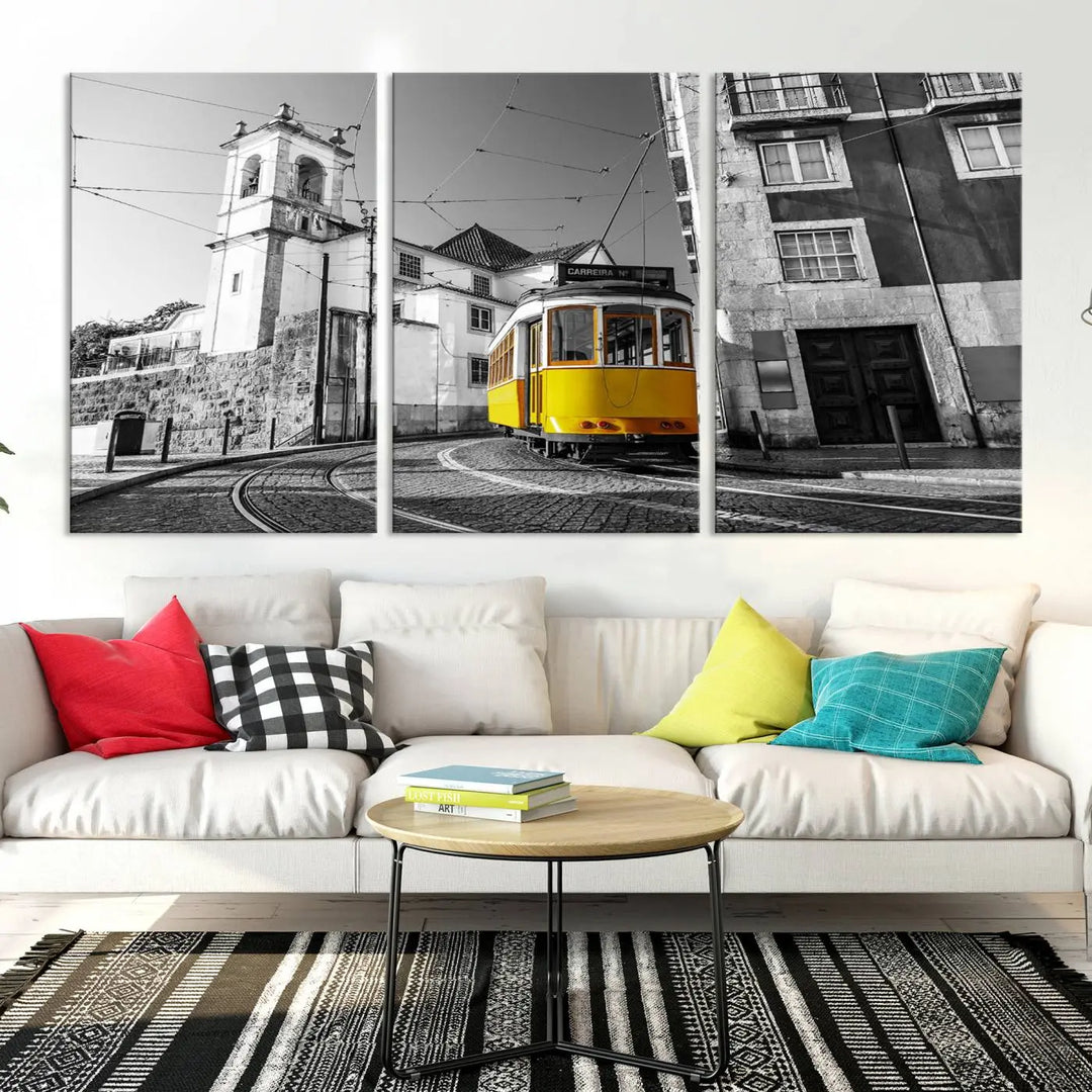 The Iconic Yellow Lisbon Tram Canvas Wall Art Print showcases a yellow tram navigating through a monochrome street scene, with a historic building in the background, exquisitely captured on museum-quality canvas.