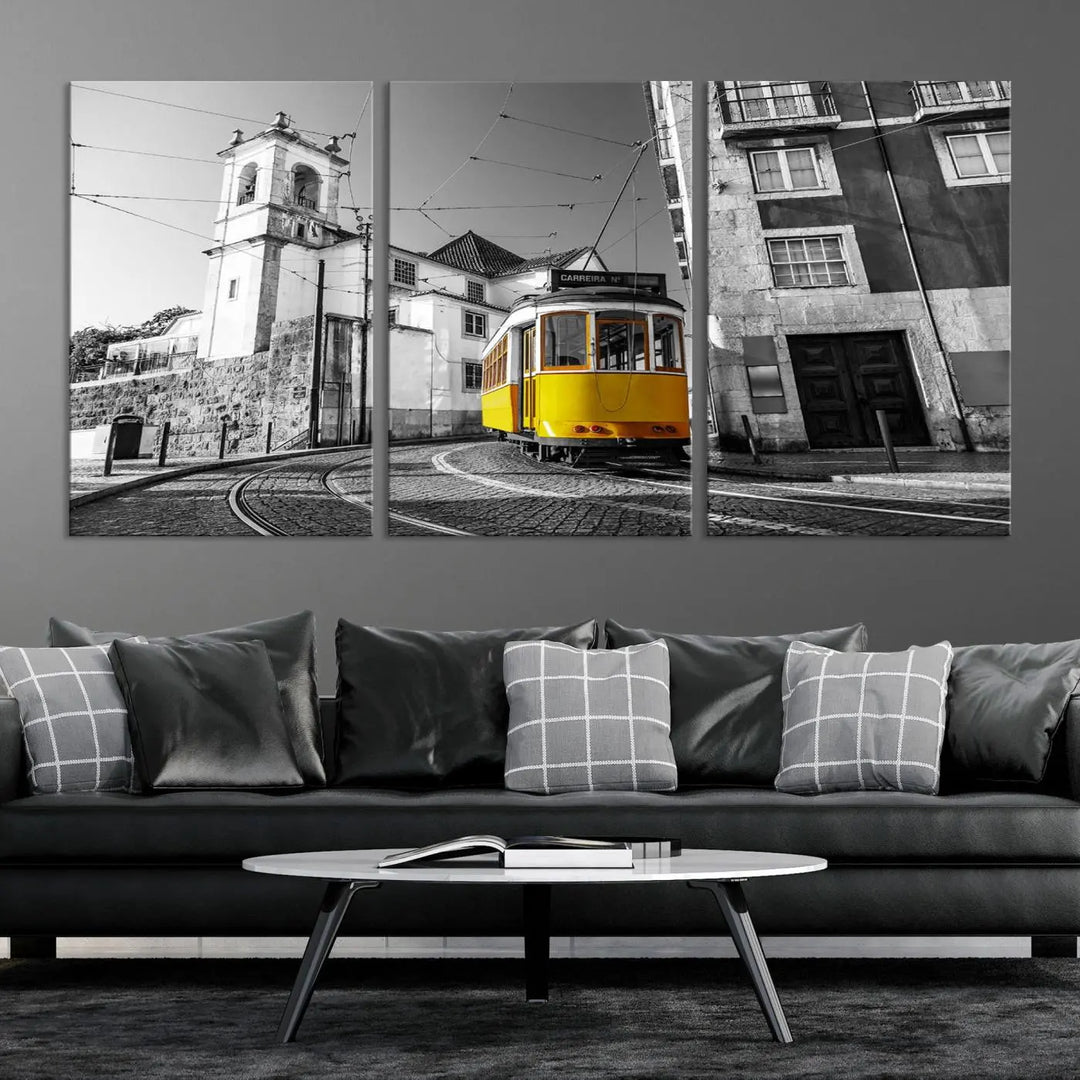 The Iconic Yellow Lisbon Tram Canvas Wall Art Print showcases a yellow tram navigating through a monochrome street scene, with a historic building in the background, exquisitely captured on museum-quality canvas.