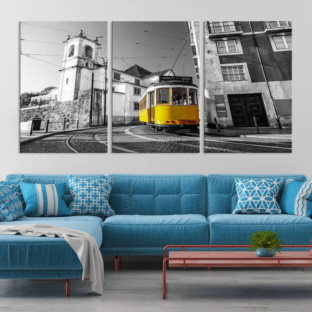 The Iconic Yellow Lisbon Tram Canvas Wall Art Print showcases a yellow tram navigating through a monochrome street scene, with a historic building in the background, exquisitely captured on museum-quality canvas.