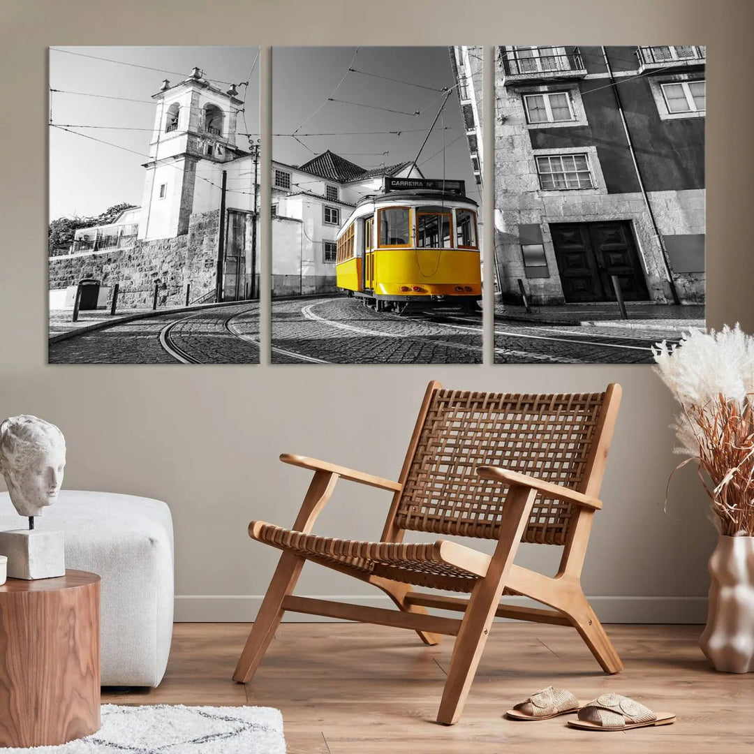 The Iconic Yellow Lisbon Tram Canvas Wall Art Print showcases a yellow tram navigating through a monochrome street scene, with a historic building in the background, exquisitely captured on museum-quality canvas.