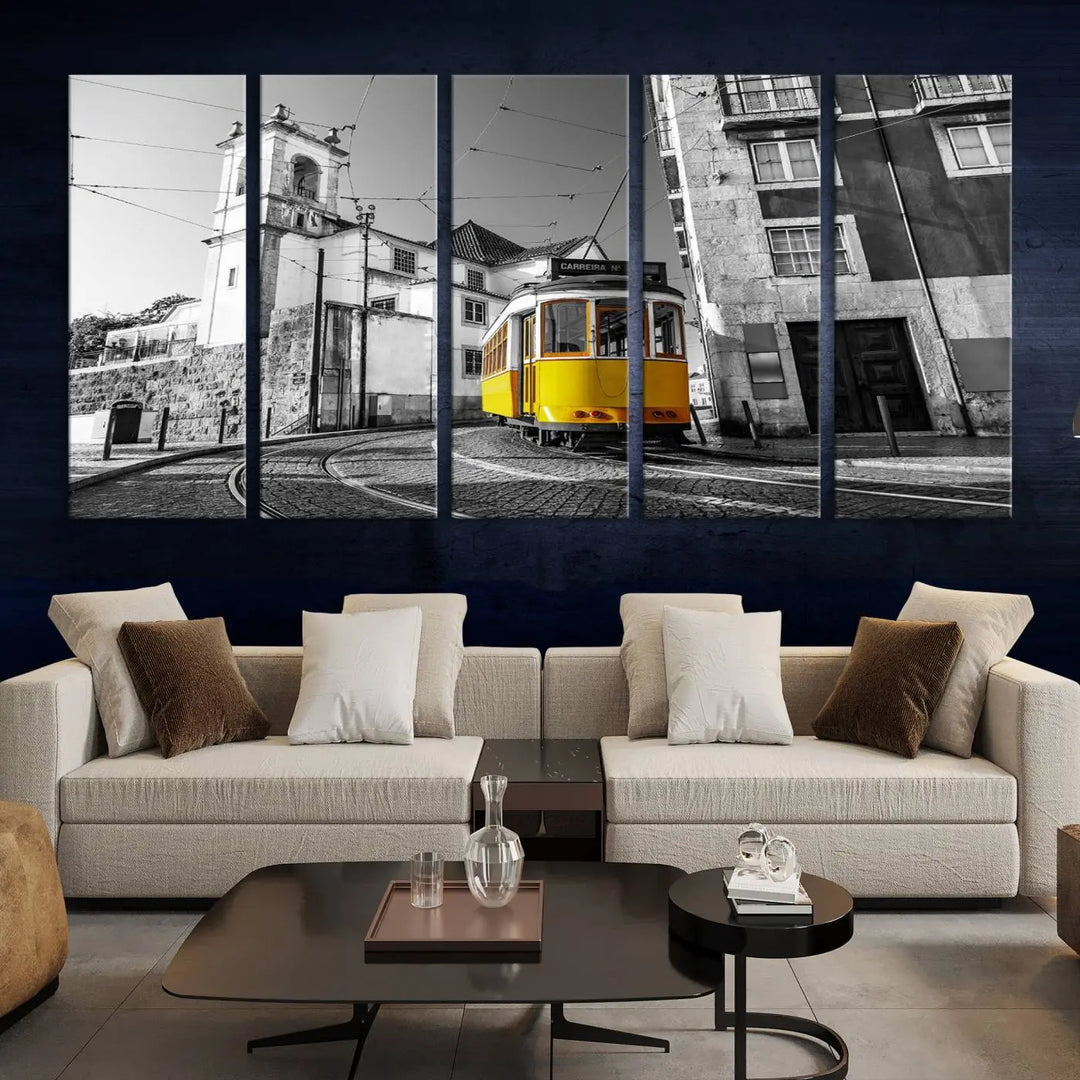 The Iconic Yellow Lisbon Tram Canvas Wall Art Print showcases a yellow tram navigating through a monochrome street scene, with a historic building in the background, exquisitely captured on museum-quality canvas.