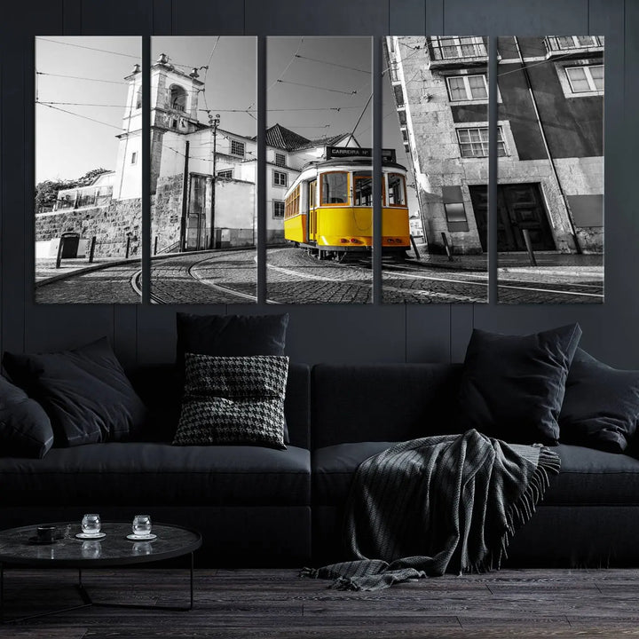 The Iconic Yellow Lisbon Tram Canvas Wall Art Print showcases a yellow tram navigating through a monochrome street scene, with a historic building in the background, exquisitely captured on museum-quality canvas.