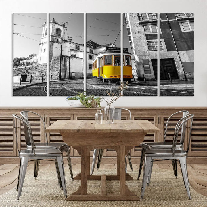 The Iconic Yellow Lisbon Tram Canvas Wall Art Print showcases a yellow tram navigating through a monochrome street scene, with a historic building in the background, exquisitely captured on museum-quality canvas.