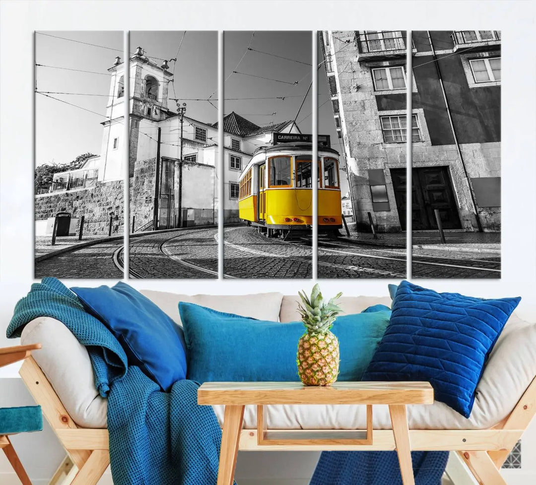 The Iconic Yellow Lisbon Tram Canvas Wall Art Print showcases a yellow tram navigating through a monochrome street scene, with a historic building in the background, exquisitely captured on museum-quality canvas.