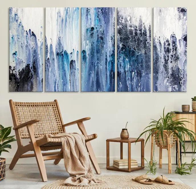 The minimalist room is adorned with the Ink Abstract Wall Art Canvas Print, featuring a museum-quality triptych in blue and white elegantly displayed. Rendered on UV-protective canvas for lasting vibrancy.