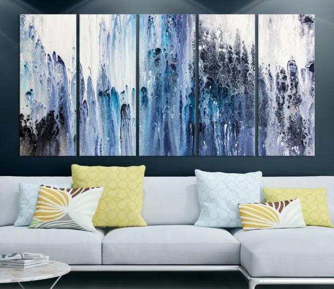 The minimalist room is adorned with the Ink Abstract Wall Art Canvas Print, featuring a museum-quality triptych in blue and white elegantly displayed. Rendered on UV-protective canvas for lasting vibrancy.