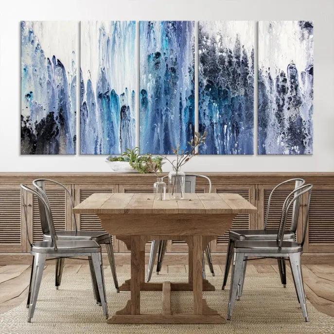 The minimalist room is adorned with the Ink Abstract Wall Art Canvas Print, featuring a museum-quality triptych in blue and white elegantly displayed. Rendered on UV-protective canvas for lasting vibrancy.