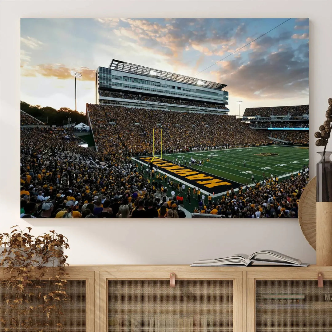 The Iowa University Hawkeyes Football Team Print, featuring a depiction of Kinnick Stadium in Iowa City at sunset and finished on a gallery-quality canvas, is displayed prominently.