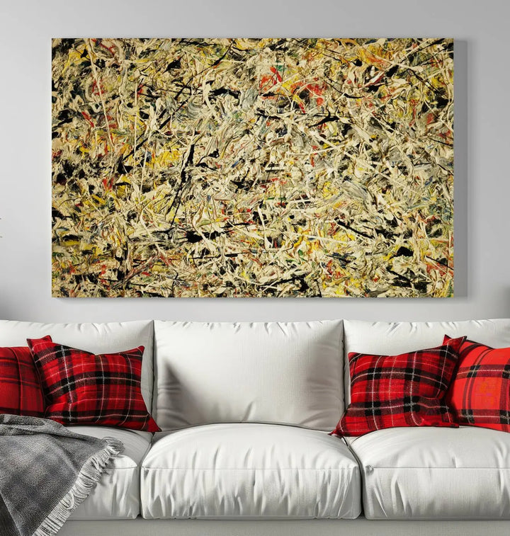 A Jackson Pollock Yellow Abstract Wall Art Canvas Print, featuring chaotic splashes of black, yellow, and red on a museum-quality canvas, is displayed prominently.