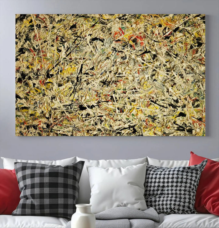 A Jackson Pollock Yellow Abstract Wall Art Canvas Print, featuring chaotic splashes of black, yellow, and red on a museum-quality canvas, is displayed prominently.