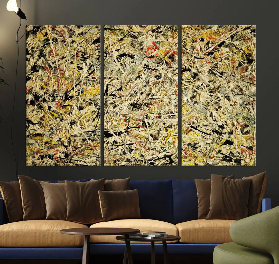 A Jackson Pollock Yellow Abstract Wall Art Canvas Print, featuring chaotic splashes of black, yellow, and red on a museum-quality canvas, is displayed prominently.