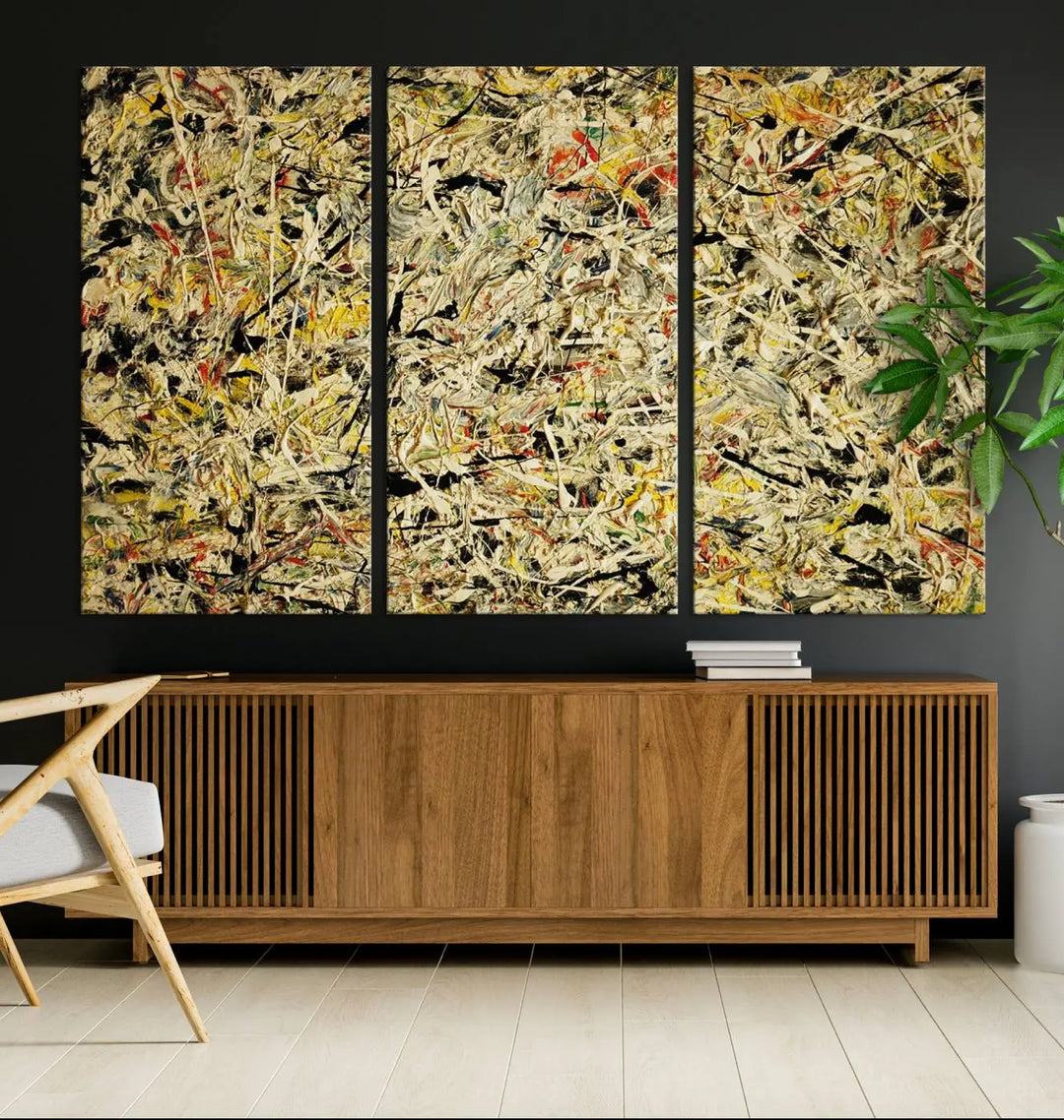 A Jackson Pollock Yellow Abstract Wall Art Canvas Print, featuring chaotic splashes of black, yellow, and red on a museum-quality canvas, is displayed prominently.