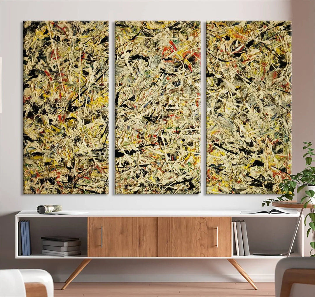 A Jackson Pollock Yellow Abstract Wall Art Canvas Print, featuring chaotic splashes of black, yellow, and red on a museum-quality canvas, is displayed prominently.