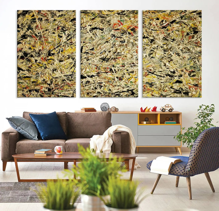 A Jackson Pollock Yellow Abstract Wall Art Canvas Print, featuring chaotic splashes of black, yellow, and red on a museum-quality canvas, is displayed prominently.