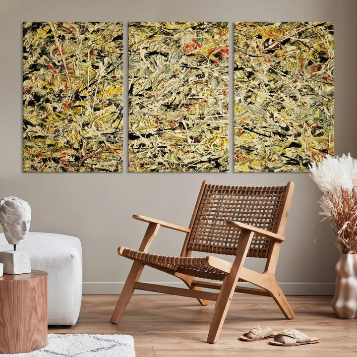 A Jackson Pollock Yellow Abstract Wall Art Canvas Print, featuring chaotic splashes of black, yellow, and red on a museum-quality canvas, is displayed prominently.