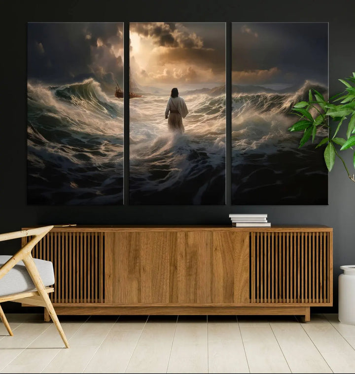 The Jesus Walking on Water Wall Art Canvas Print, a triptych mural featuring Jesus traversing turbulent waves with a distant boat under a dramatic sky, embodies spiritual art and religious decor. It inspires reflection and tranquility in the space.