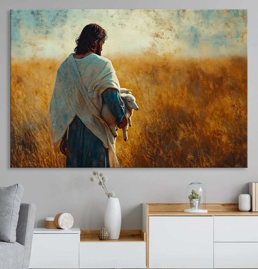 The Jesus the Good Shepherd Wall Art Canvas Print, featuring a figure in a robe holding a lamb amidst a golden field at sunset, adds serene beauty to the wall and embodies inspirational Christian decor.