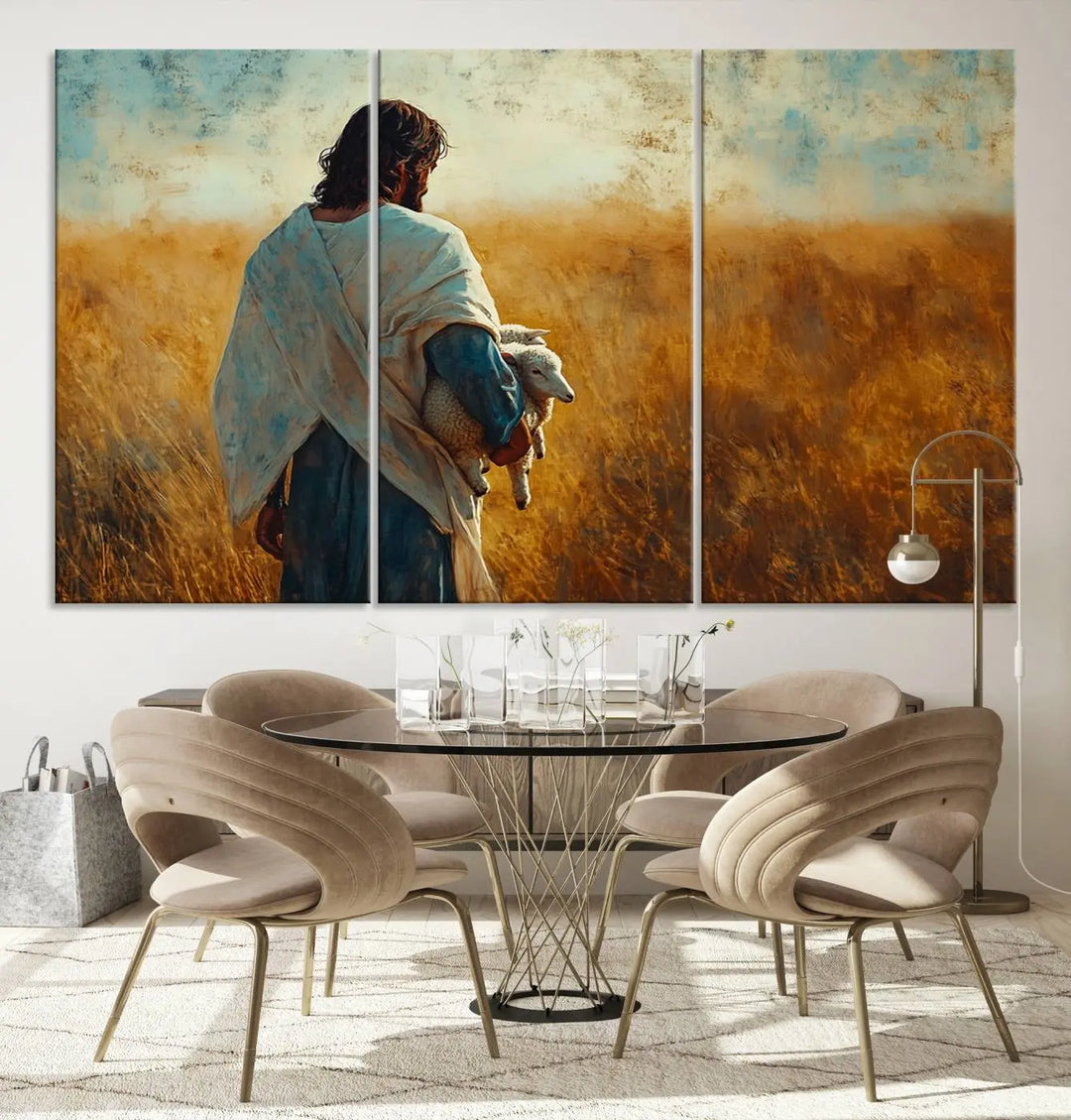 The Jesus the Good Shepherd Wall Art Canvas Print, featuring a figure in a robe holding a lamb amidst a golden field at sunset, adds serene beauty to the wall and embodies inspirational Christian decor.