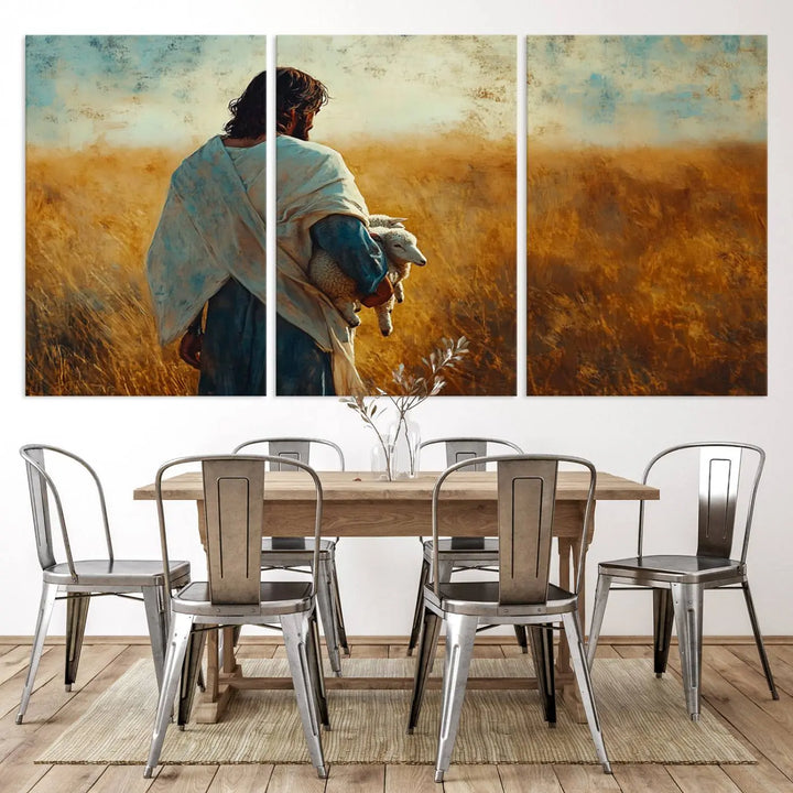 The Jesus the Good Shepherd Wall Art Canvas Print, featuring a figure in a robe holding a lamb amidst a golden field at sunset, adds serene beauty to the wall and embodies inspirational Christian decor.