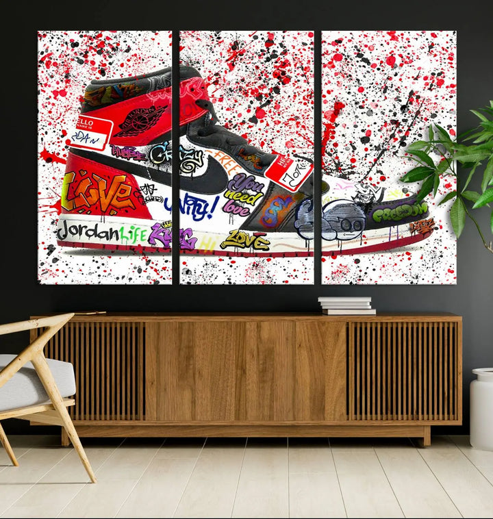 A large triptych mural titled "Jordan Shoes Graffiti Wall Art Canvas Print - Jordan Graffiti Canvas Wall Art" features images of Jordan Shoes against a splattered paint background that resembles graffiti, making it an ideal choice for sneakerheads and urban art lovers.