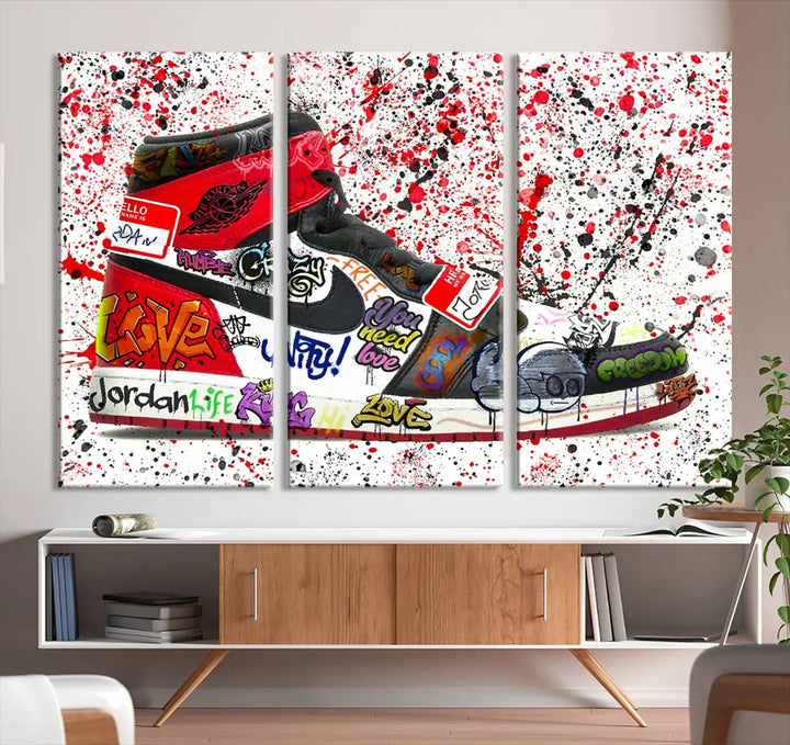 A large triptych mural titled "Jordan Shoes Graffiti Wall Art Canvas Print - Jordan Graffiti Canvas Wall Art" features images of Jordan Shoes against a splattered paint background that resembles graffiti, making it an ideal choice for sneakerheads and urban art lovers.