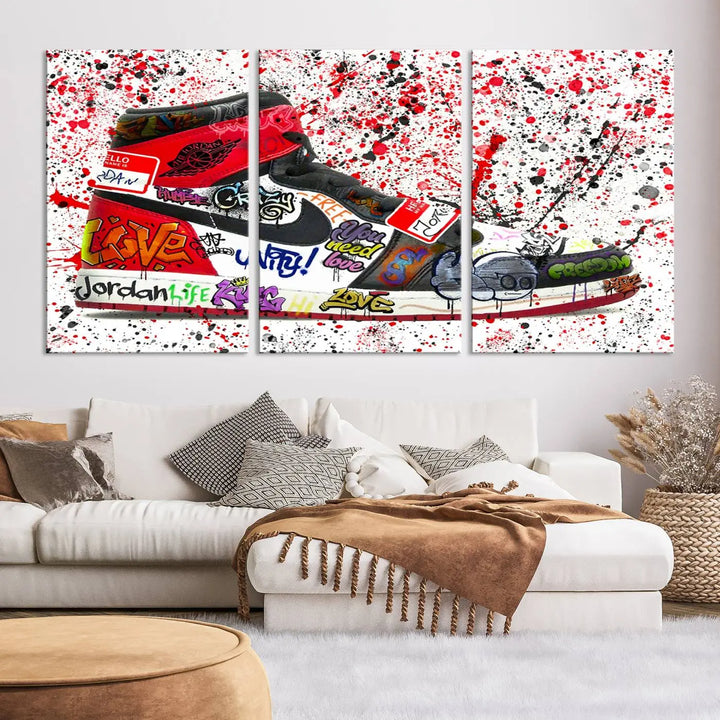 A large triptych mural titled "Jordan Shoes Graffiti Wall Art Canvas Print - Jordan Graffiti Canvas Wall Art" features images of Jordan Shoes against a splattered paint background that resembles graffiti, making it an ideal choice for sneakerheads and urban art lovers.