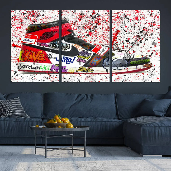 A large triptych mural titled "Jordan Shoes Graffiti Wall Art Canvas Print - Jordan Graffiti Canvas Wall Art" features images of Jordan Shoes against a splattered paint background that resembles graffiti, making it an ideal choice for sneakerheads and urban art lovers.