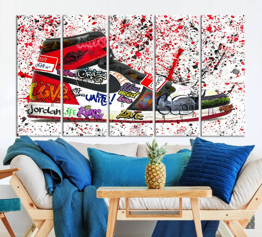 A large triptych mural titled "Jordan Shoes Graffiti Wall Art Canvas Print - Jordan Graffiti Canvas Wall Art" features images of Jordan Shoes against a splattered paint background that resembles graffiti, making it an ideal choice for sneakerheads and urban art lovers.