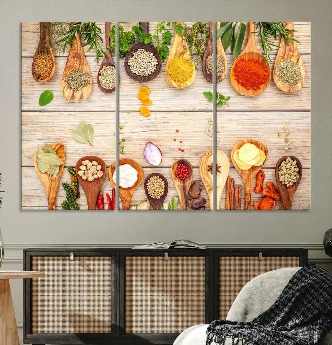 The Kitchen Spice on the Table Wall Art Canvas Print features a triptych of wooden spoons with an array of spices and herbs, artfully presented on a wooden background. Printed on museum-quality canvas, it guarantees lasting elegance and durability.