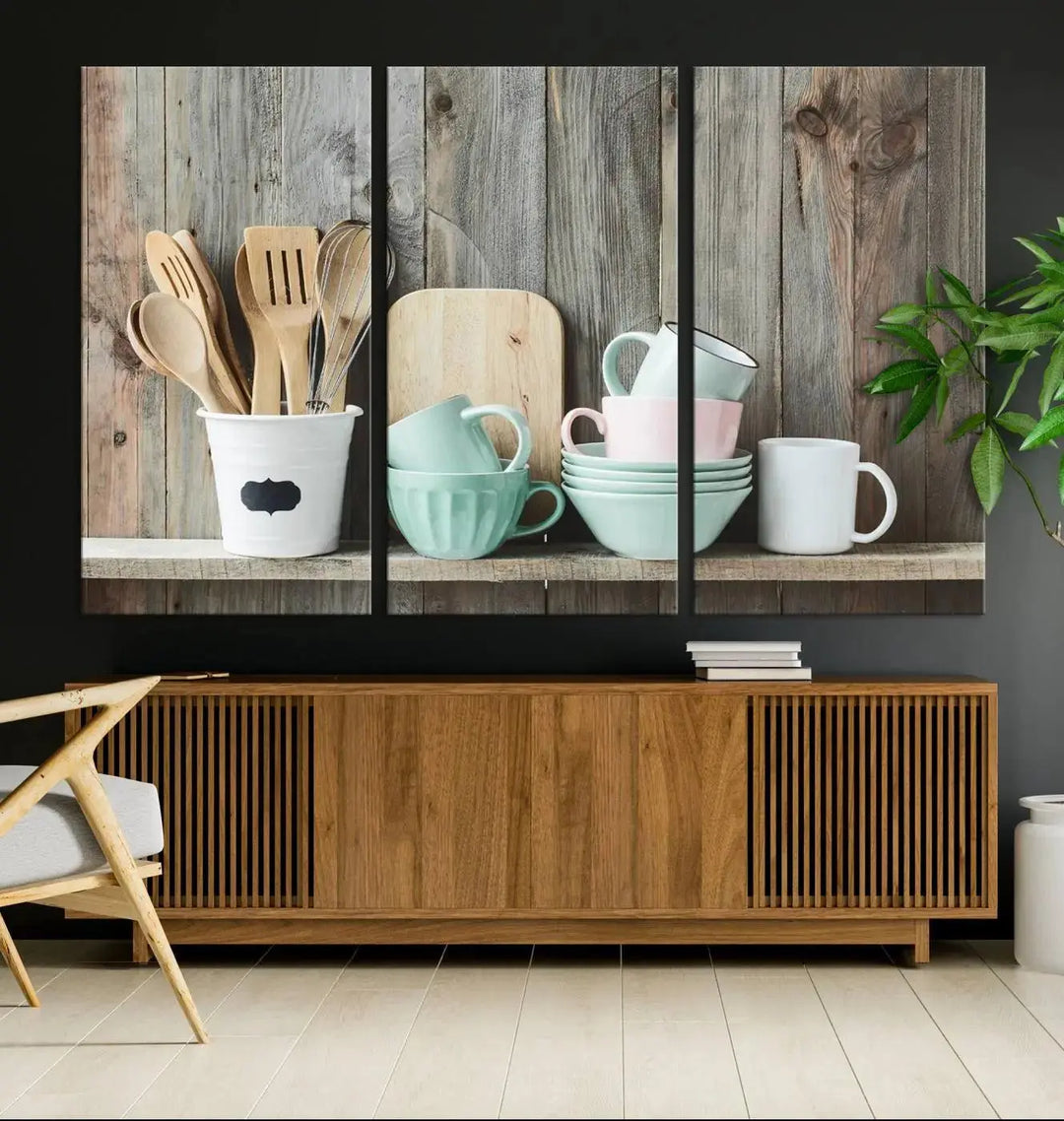 The "Kitchenware on Rustic Woods Canvas" features a triptych of kitchen utensils and cups. This piece evokes artistry reminiscent of museum-quality canvases, with each detail appearing as if handcrafted in the USA.