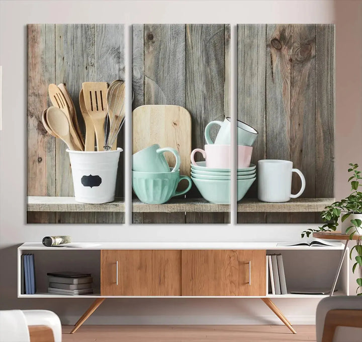 The "Kitchenware on Rustic Woods Canvas" features a triptych of kitchen utensils and cups. This piece evokes artistry reminiscent of museum-quality canvases, with each detail appearing as if handcrafted in the USA.