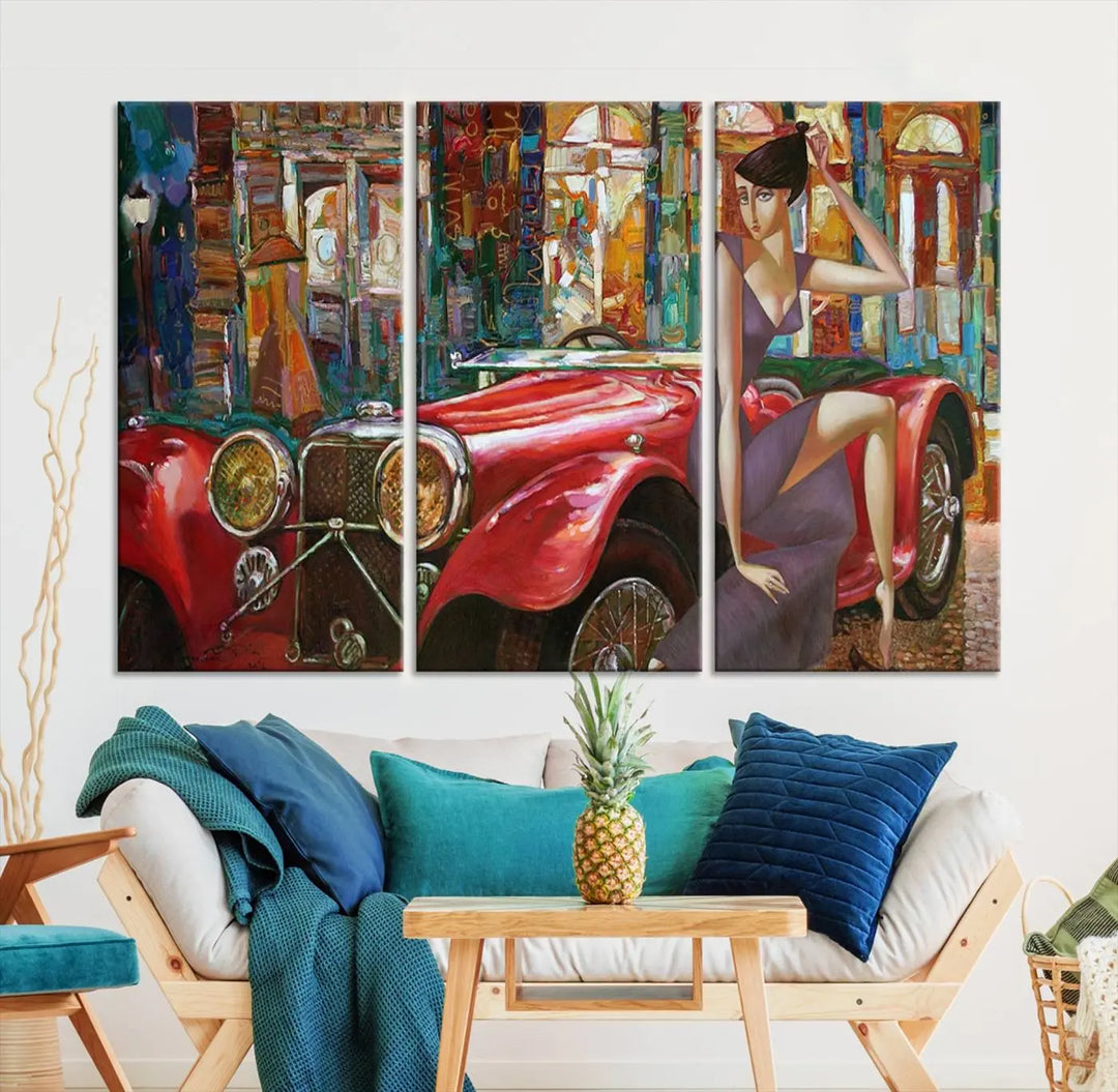 The modern living room is adorned with the "Lady With a Red Antique Car Wall Art Canvas Print," a triptych featuring a vintage red car and woman. This museum-quality canvas is ready to hang with a UV-protective coating to ensure lasting vibrancy.