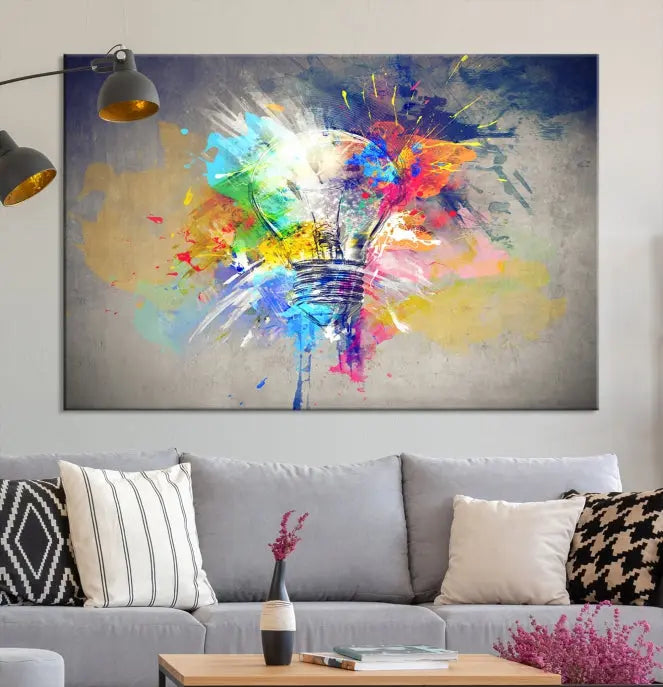 The Lamp Abstract Color Wall Art Canvas Print showcases vibrant splashes of color around a light bulb design. This museum-quality canvas comes ready to hang and features a UV-protective coating to keep its colors vivid and striking for years.