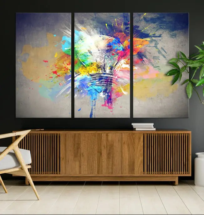 The Lamp Abstract Color Wall Art Canvas Print showcases vibrant splashes of color around a light bulb design. This museum-quality canvas comes ready to hang and features a UV-protective coating to keep its colors vivid and striking for years.