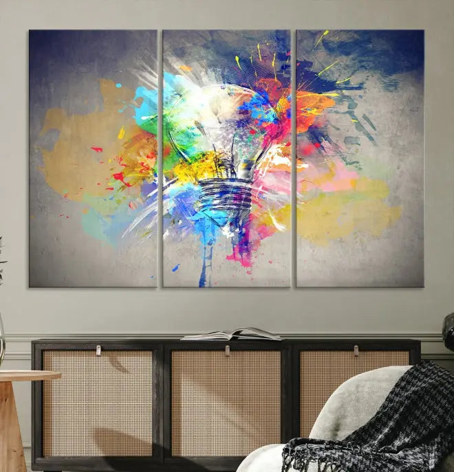 The Lamp Abstract Color Wall Art Canvas Print showcases vibrant splashes of color around a light bulb design. This museum-quality canvas comes ready to hang and features a UV-protective coating to keep its colors vivid and striking for years.