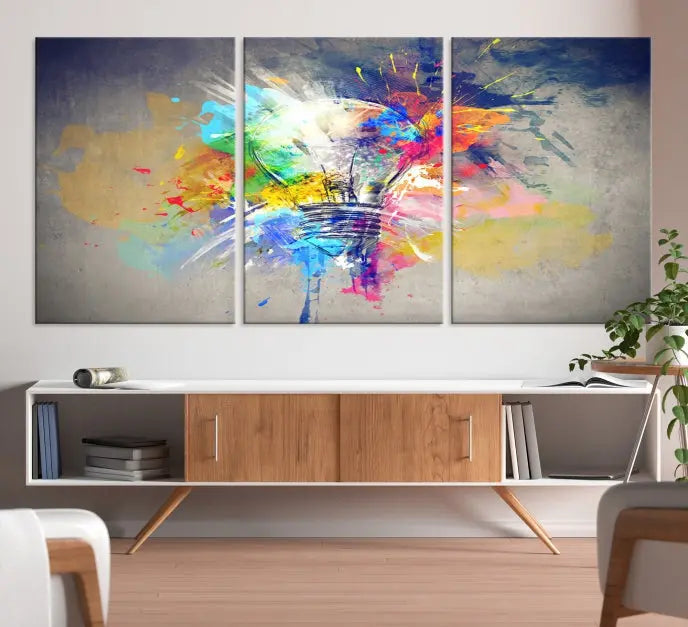 The Lamp Abstract Color Wall Art Canvas Print showcases vibrant splashes of color around a light bulb design. This museum-quality canvas comes ready to hang and features a UV-protective coating to keep its colors vivid and striking for years.